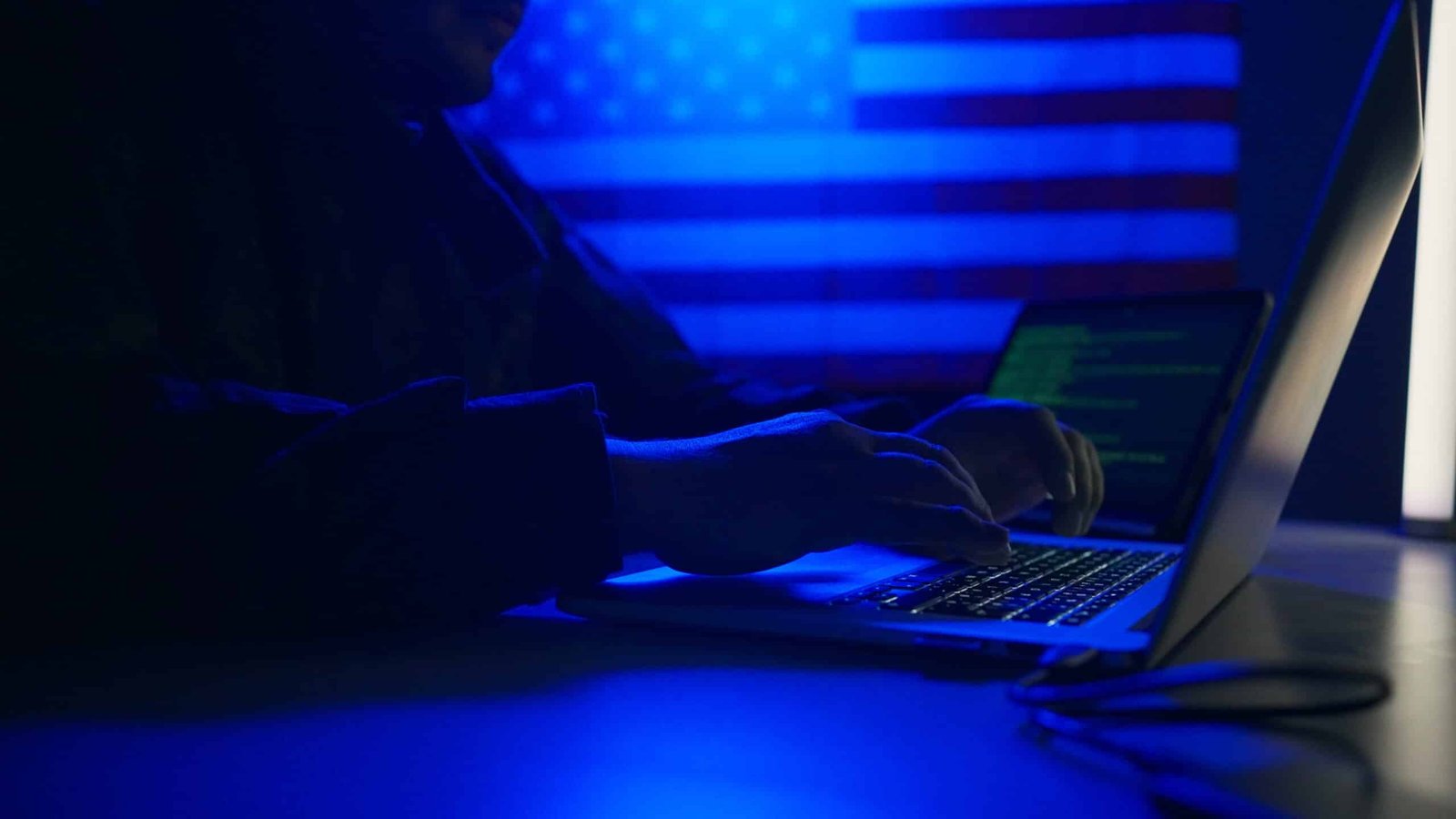 hacker with laptop and usa flag in background cyb 2023 11 27 05 04 44 utc scaled